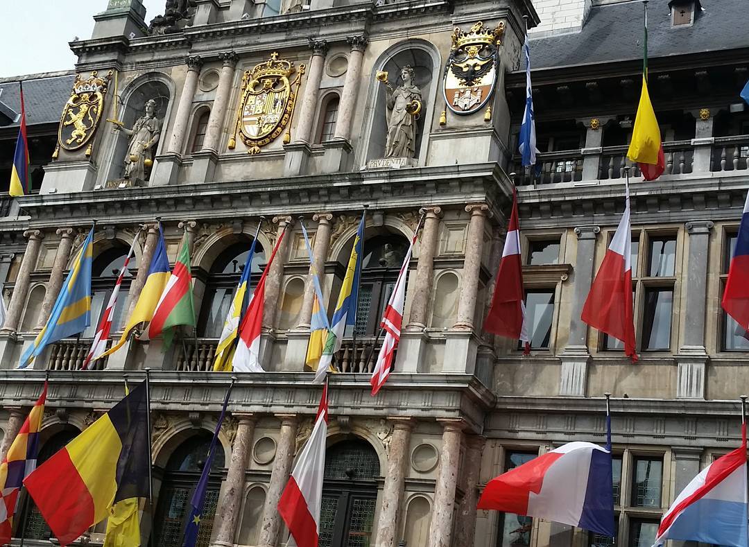 An old building with lots of flags