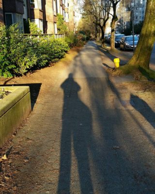 My shadow stretching in front of me on a quiet West End sidewalk