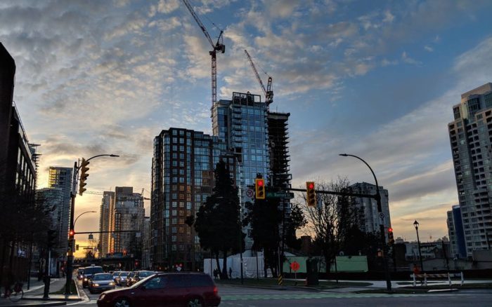 Buildings and construction crane in the morning