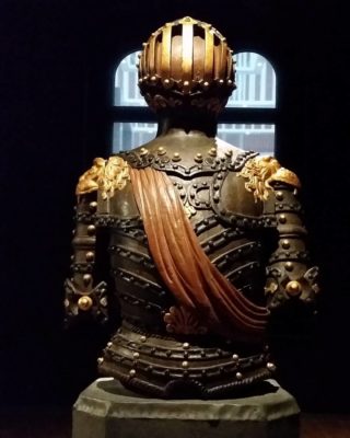 wooden figure with orange sash