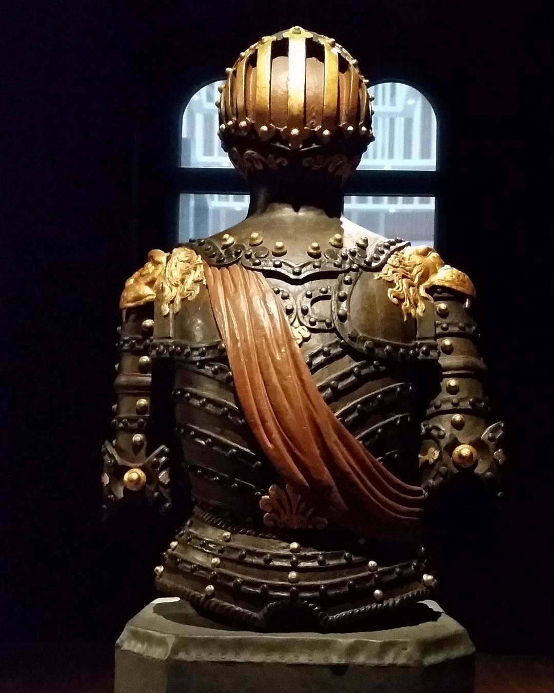 wooden figure with orange sash