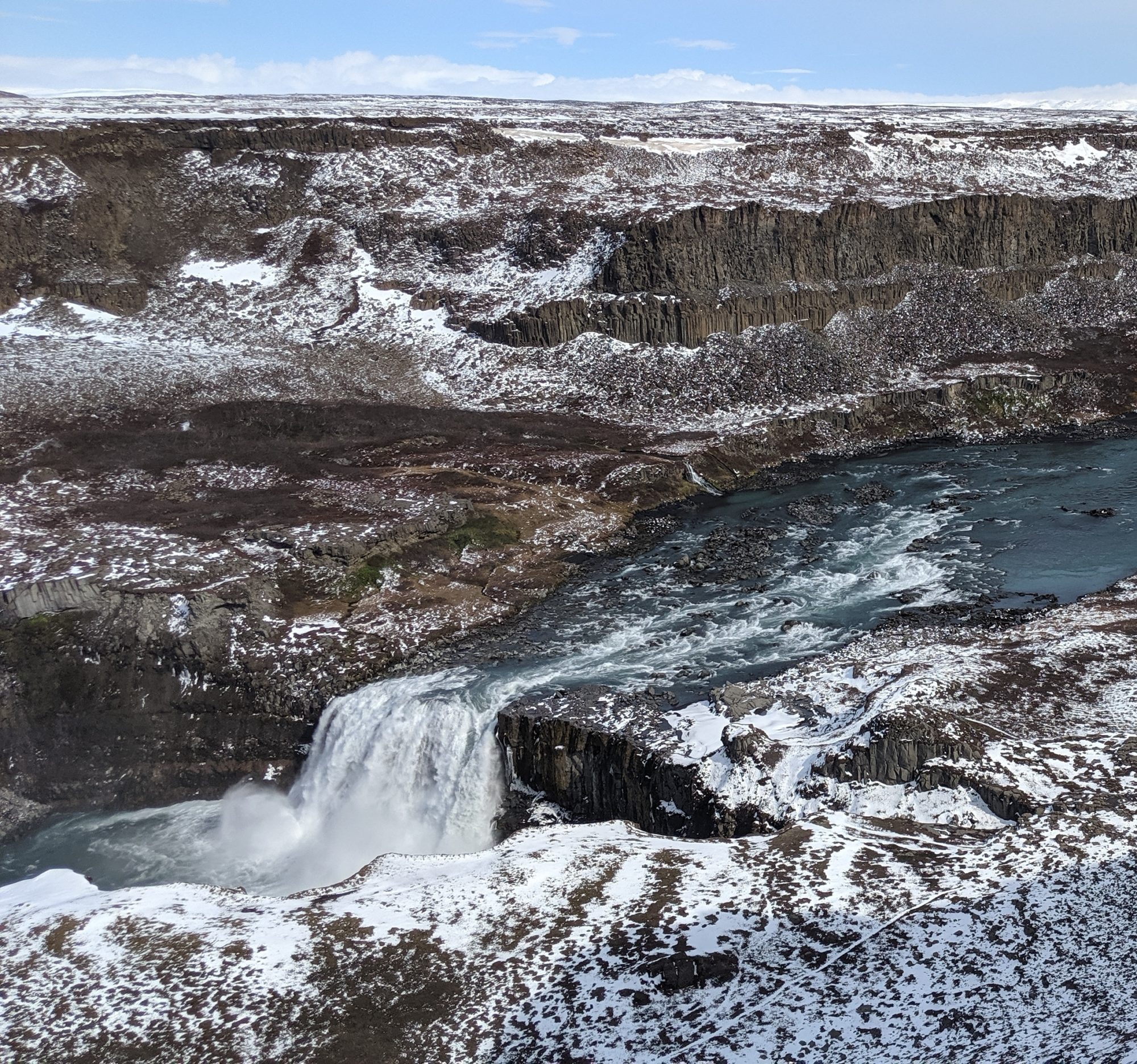 a little waterfall in brown and snowy landscape