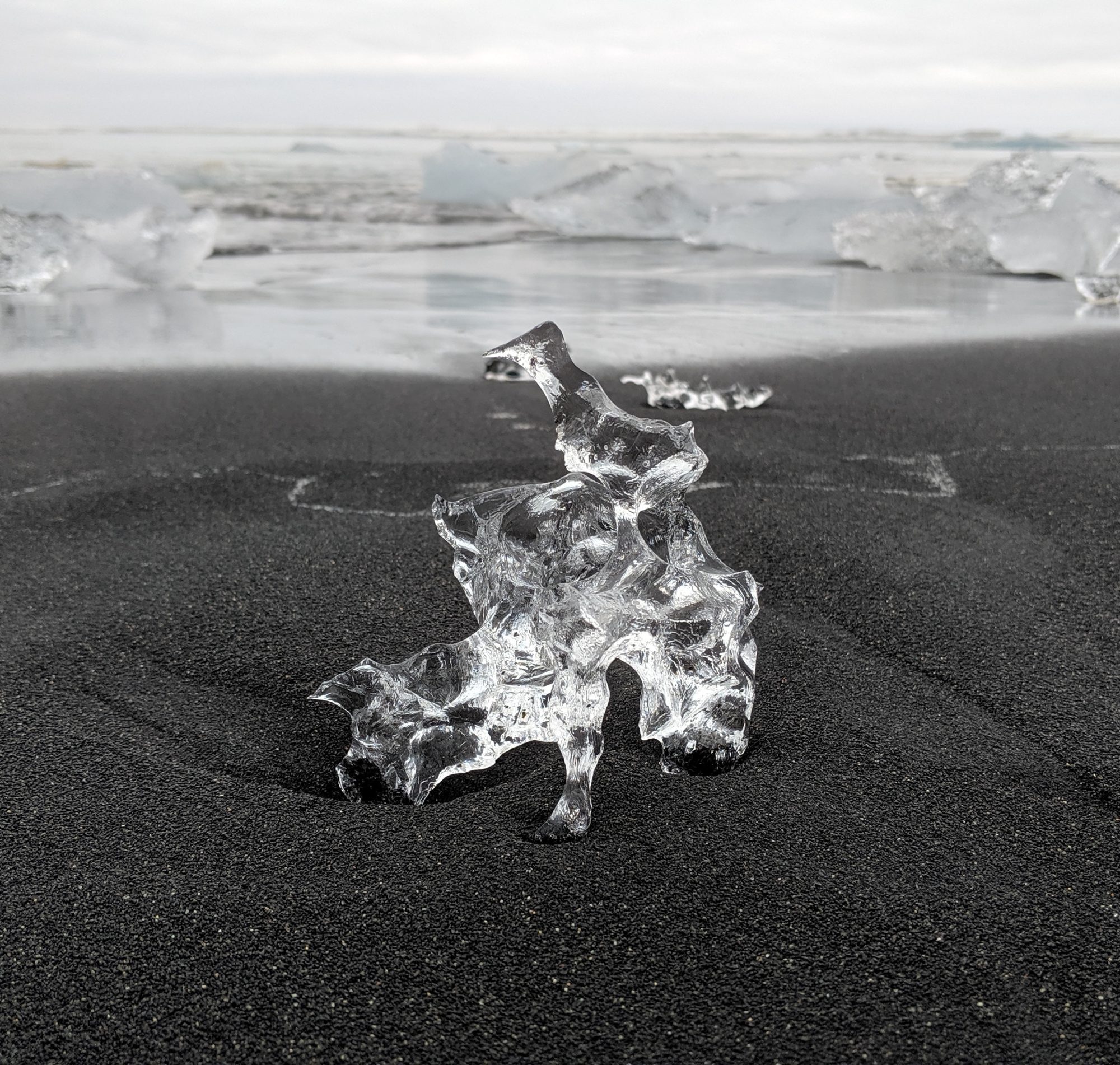 a bit of ice on black sand