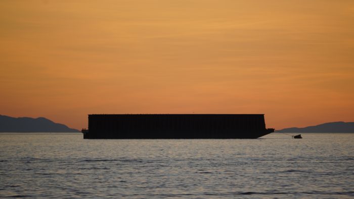 Large barge and tiny tug