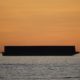 Large barge and tiny tug