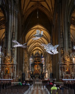Silvery bird-like art suspended from the ceiling of St Stephan's Cathedral