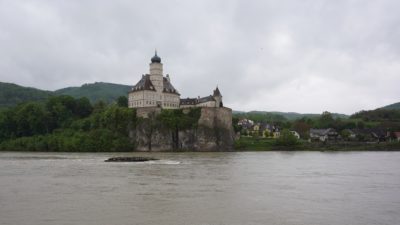 Castle Schönbühel, a pretty white castle with black roofs, by the river