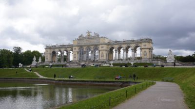The Gloriette, a colonnated arcade at the top of a hill, overlooking a pond