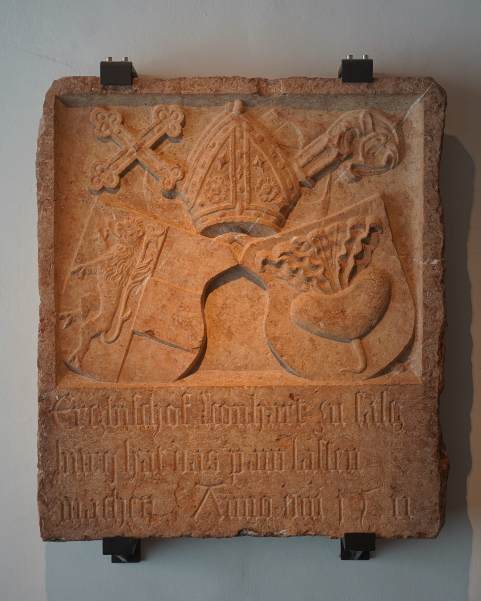 Combined coats of arms: a turnip on the right, a lion on the left, and on top are a cross, miter and crook