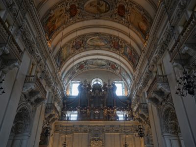 Organ surrounded by intricate and painted arches