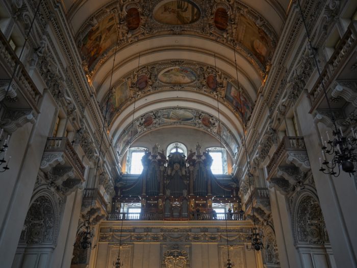 Organ surrounded by intricate and painted arches