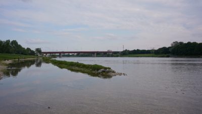 The Danube reflecting some clouds. A bridge in the distance