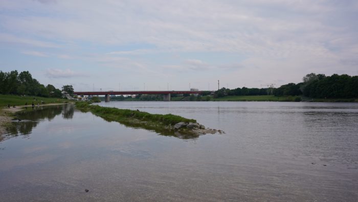 The Danube reflecting some clouds. A bridge in the distance