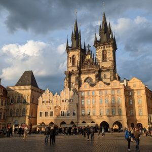 The Church of Our Lady Before Týn, from the Old Town Square. The light is low and golden, and there are a few dark clouds in the sky