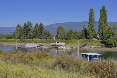 The Alouette River, with a grounded and rotting boat on the opposite shore, next to a ruined quay