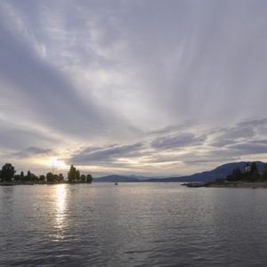 A view out from Sunset Beach. The evening sky is blue-indigo, and the last light is pushing through the clouds.
