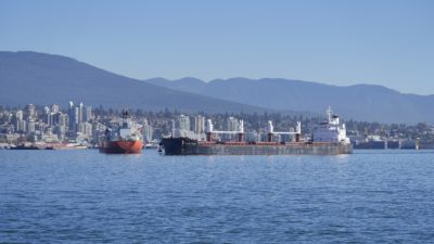 A few big boats in the harbour, with North Vancouver in the background