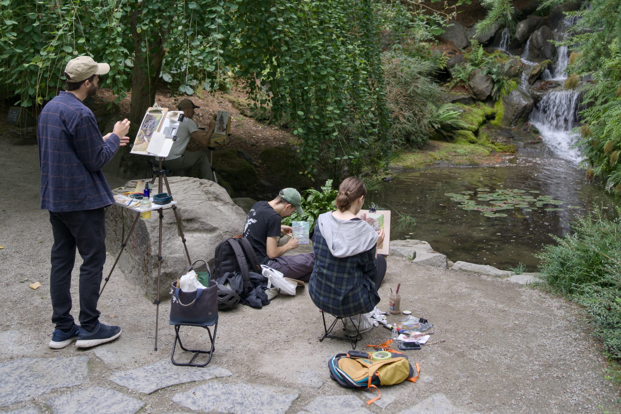 Some amateur painters painting a little waterfall